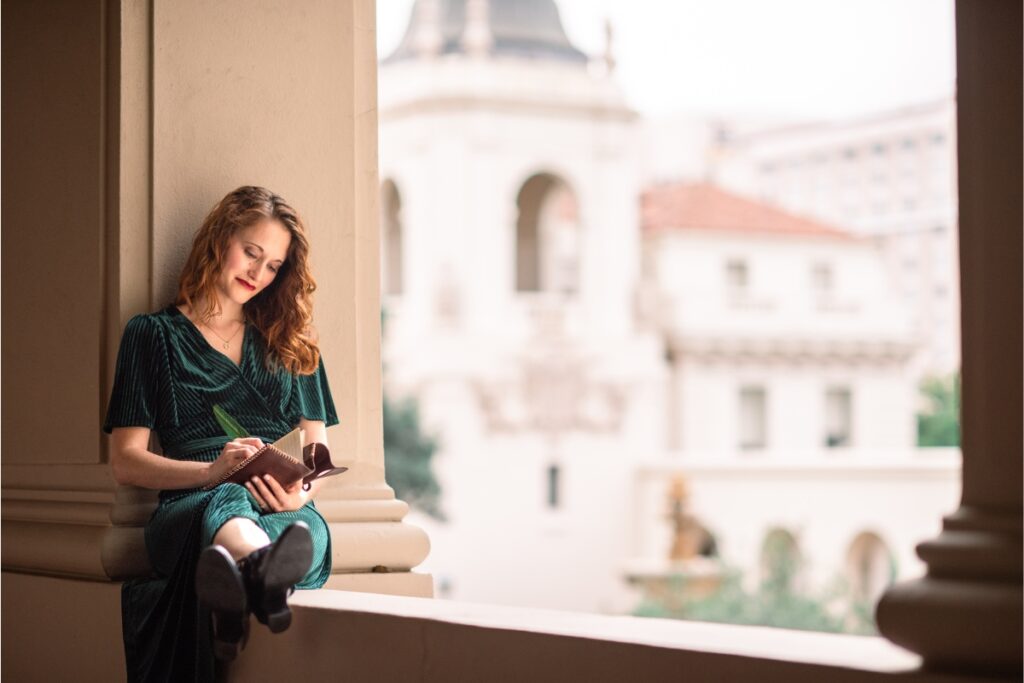 K.T. Jay using her writing system and writing a draft in an inspiring location.